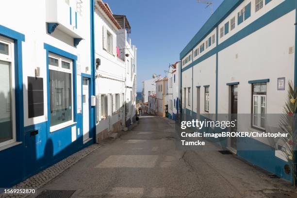 colourful house facades in an alley in praia do burgau, faro district, algarve, portugal - burgau portugal stock pictures, royalty-free photos & images