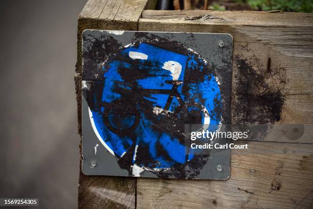 Sign is vandalised on a low traffic neighbourhood barrier on August 1, 2023 in London, England. Prime Minister Rishi Sunak has called for a review of...