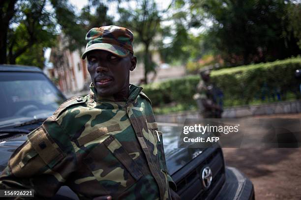 The head of the M23 rebel military forces, Brigadier-General Sultani Makenga , leans on a car on November 25, 2012 on the grounds of a military...