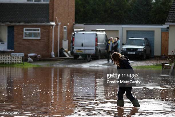 Woman wades through flood water in the centre of the village of Ruishton, near Taunton, on November 25, 2012 in Somerset, England. Another band of...