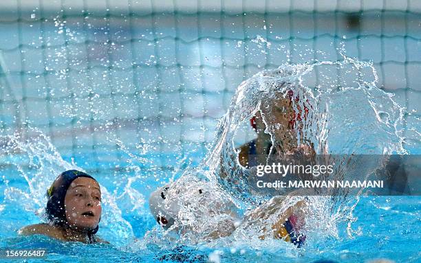 Yating Sun of China vies for the ball against Anna Zubkova of Kazakhstan as she tries to block the shot during the two teams water polo game at the...