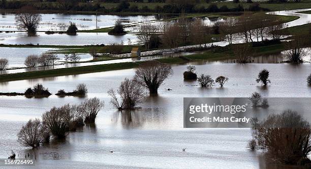 Flood water can be seen in fields surrounding the Glastonbury Tor on the Somerset Levels, on November 25, 2012 near Glastonbury, England. Another...