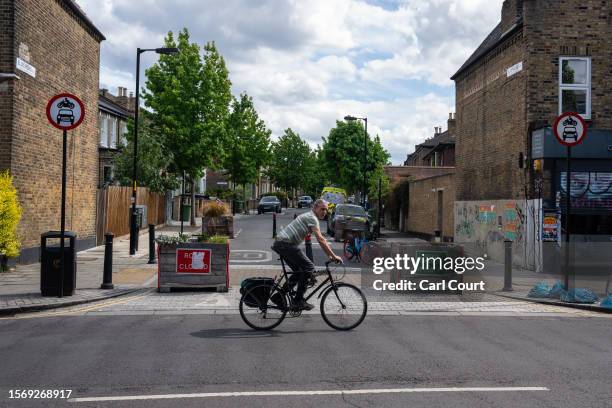 Cyclist passes a low traffic neighbourhood barrier on August 1, 2023 in London, England. Prime Minister Rishi Sunak has called for a review of low...