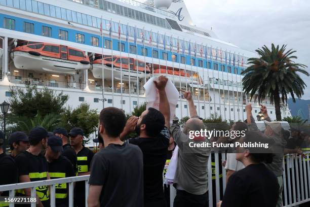 Demonstrators protest against the arrival of the Astoria Grande cruise ship, with some 800 mostly Russian passengers on board.