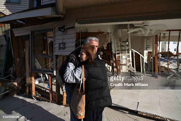 Lou Friedella gets a hug from his wife Susan in front of their beach house that was damaged by Superstorm Sandy on November 25, 2012 in Ortley Beach,...