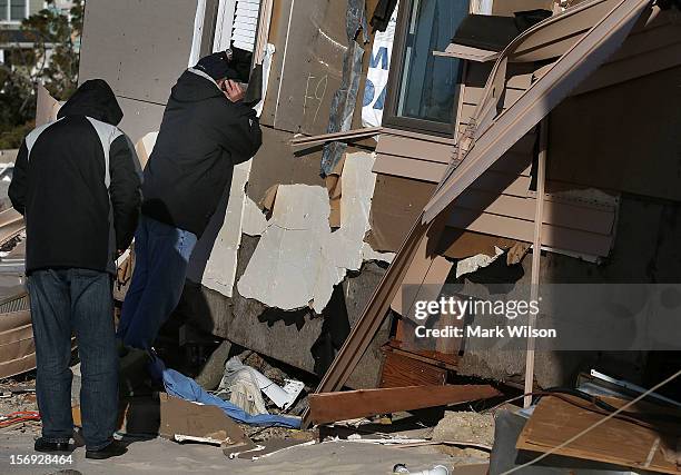 People check out a home damaged by Superstorm Sandy on November 25, 2012 in Ortley Beach, New Jersey. New Jersey Gov. Christie estimated that...