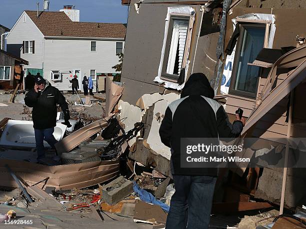 People check out a home damaged by Superstorm Sandy on November 25, 2012 in Ortley Beach, New Jersey. New Jersey Gov. Christie estimated that...