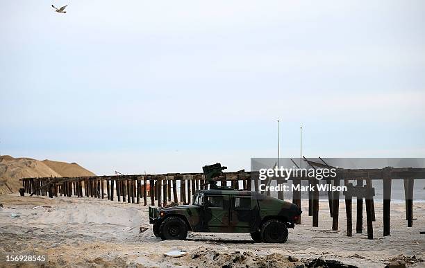 National Guard vehicle stands watch near the board walk that was damaged by Superstorm Sandy on November 25, 2012 in Ortley Beach, New Jersey. New...