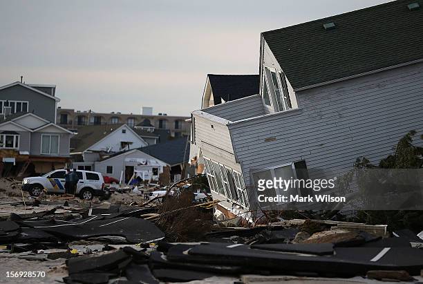 Police stand guard near beach homes that were damaged by Superstorm Sandy on November 25, 2012 in Ortley Beach, New Jersey. New Jersey Gov. Christie...