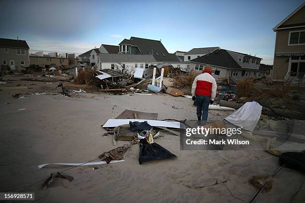 David Mccue looks for pieces of his beach house that was completely demolished by Superstorm Sandy on November 25, 2012 in Ortley Beach, New Jersey....