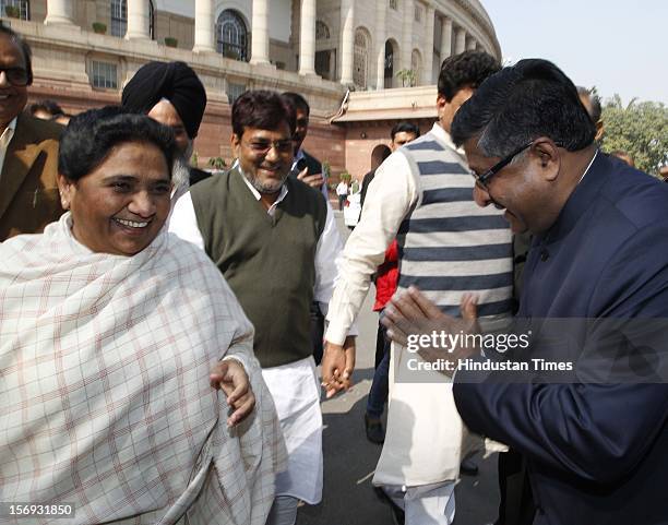Leader Mayawati with BJP Leader Ravi Shankar Prasad, at Parliament House on the first day of its winter session on November 22, 2012 in New Delhi,...