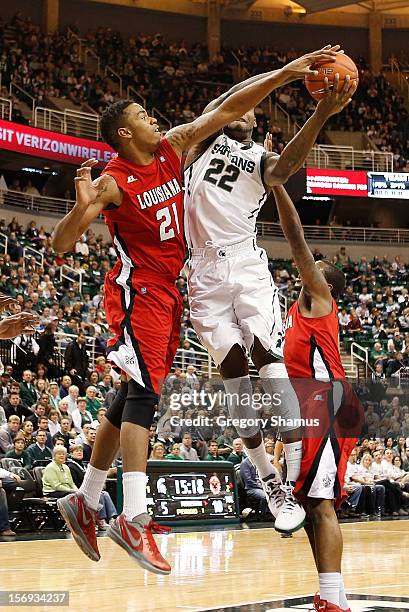 Shawn Long of the Louisiana-Lafayette Ragin' Cajuns tries to block a first half shot of Branden Dawson of the Michigan State Spartans at the Jack T....