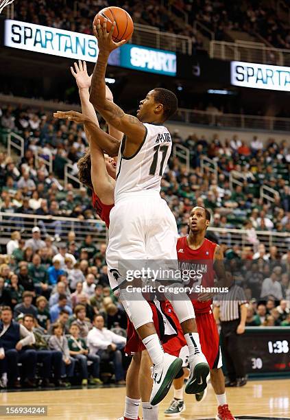 Keith Appling of the Michigan State Spartans gets a first half shot off over Steven Wronkoski of the Louisiana-Lafayette Ragin' Cajuns at the Jack T....