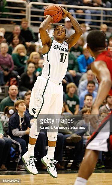 Keith Appling of the Michigan State Spartans takes a first half shot while playing the Louisiana-Lafayette Ragin' Cajuns at the Jack T. Breslin...