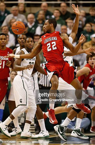 Elridge Moore of the Louisiana-Lafayette Ragin' Cajuns tries to control the ball in front of Branden Dawson of the Michigan State Spartans at the...