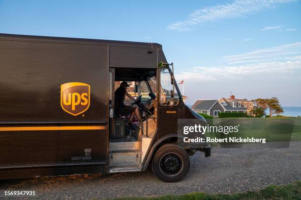 United Parcel Service truck searches for a house driving along the coast of Cape Cod on July 24, 2023 in Orleans, Massachusetts. UPS employees...