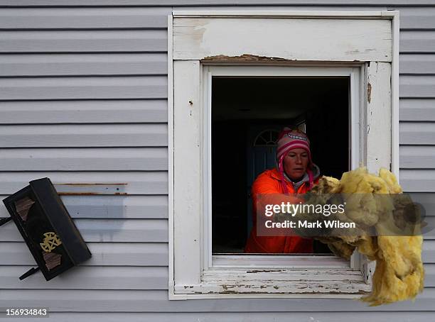 Rena McCain cleans out the first floor of her home after it was flooded by Superstorm Sandy on November 25, 2012 in Seaside Heights, New Jersey. New...