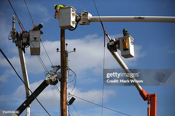 Utility workers replace a pole that was damaged by Superstorm Sandy on November 25, 2012 in Seaside Heights, New Jersey. New Jersey Gov. Christie...