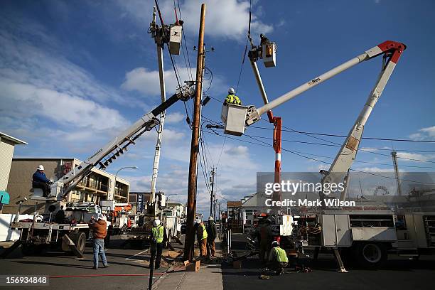 Utility workers replace a pole that was damaged by Superstorm Sandy on November 25, 2012 in Seaside Heights, New Jersey. New Jersey Gov. Christie...