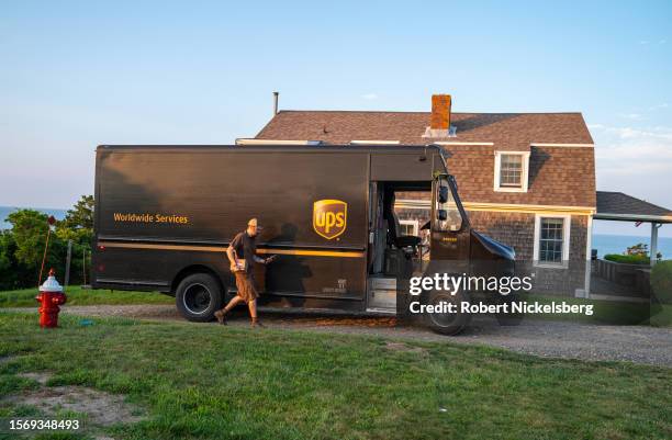 United Parcel Service driver makes a delivery along the coast of Cape Cod on July 24, 2023 in Orleans, Massachusetts. UPS employees threatened to go...