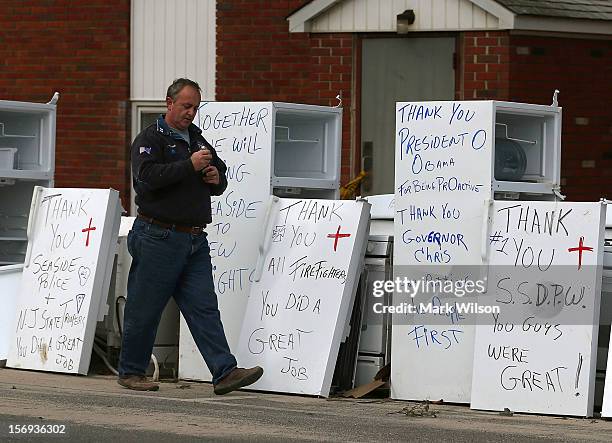 Ron Youmans walks away after writing thank you notes on refrigerators damaged by Superstorm Sandy on November 25, 2012 in Seaside Heights, New...