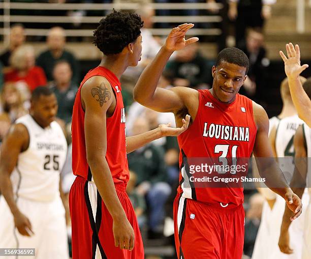 Kevin Brown celebrates with Elfrid Payton of the Louisiana-Lafayette Ragin' Cajuns after a second half three point basket while playing the Michigan...