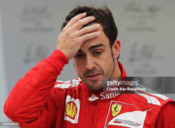 Fernando Alonso of Spain and Ferrari reacts on the podium after finishing second in the race and second in the drivers world championship following...
