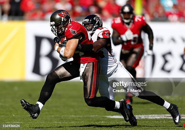 Tightend Dallas Clark of the Tampa Bay Buccaneers is tackled by linebacker Stephen Nicholas of the Atlanta Falcons during the game at Raymond James...