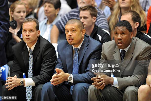 Associate Head Coach Chris Collins, Associate Head Coach Jeff Capel and Special Assistant Nate James of the Duke Blue Devils look on during a game...