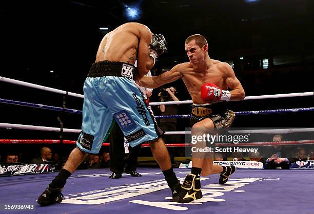 Scott Quigg connects with Rendell Munroe during their Super Bantamweight bout at the MEN Arena on November 24, 2012 in Manchester, England.