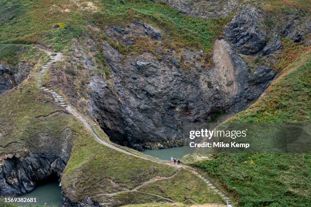 Witches Cauldron on 27th July 2023 in Moylgrove, Wales, United Kingdom. The Witches Cauldron is a collapsed cave which is fed by the tide and...