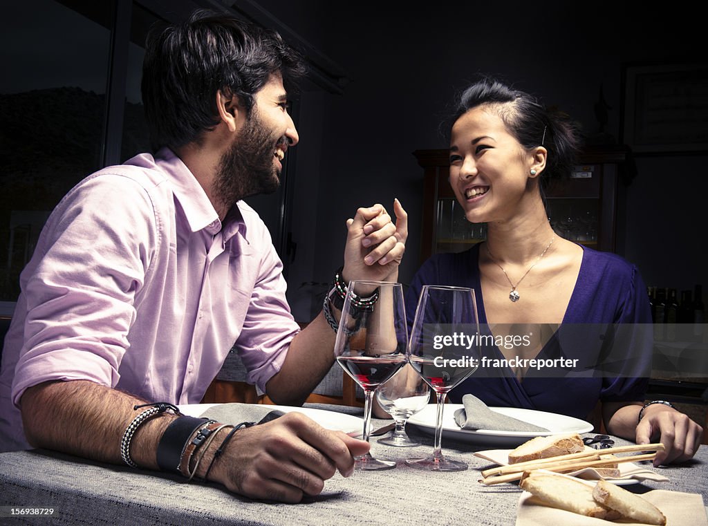 Couple smiling with red wine for St. Valentine