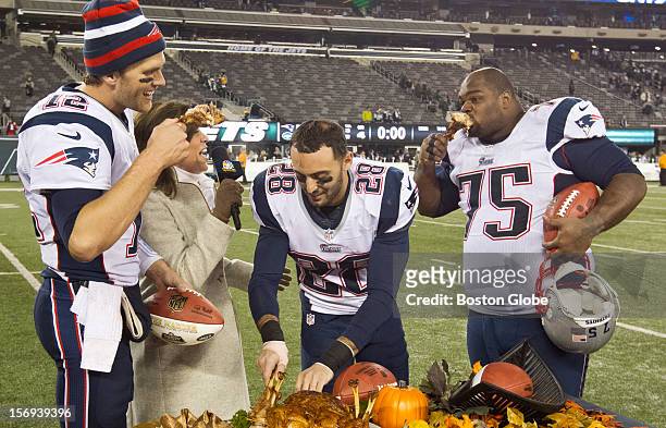 New England Patriots players, left to right, Tom Brady, Steve Gregory and Vince Wilfork join television broadcaster Michele Tafoya eating turkey legs...