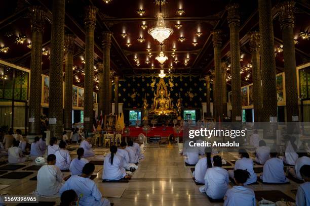 Nuns pray inside of a temple on the grounds of Wat Asokaram during Asalha Puja Day in Samut Prakan, Thailand on August 1, 2023. Asalha Puja Day, also...