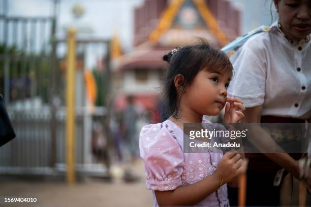 Girl attends pray ritual at Wat Asokaram on Asalha Puja Day in Samut Prakan, Thailand on August 1, 2023. Asalha Puja Day, also known as Dhamma Day,...