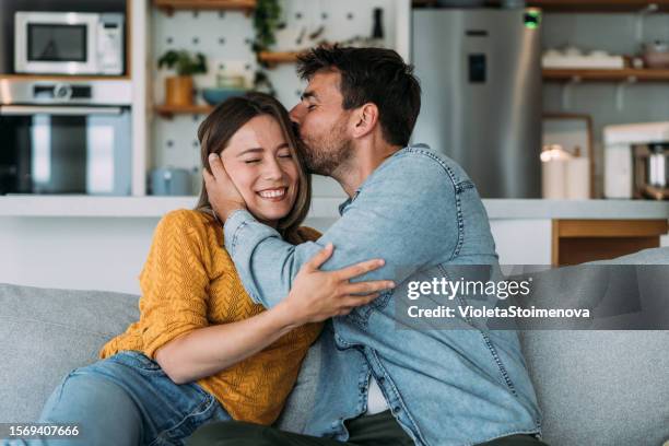 happy couple at home. - two people hugging stock pictures, royalty-free photos & images