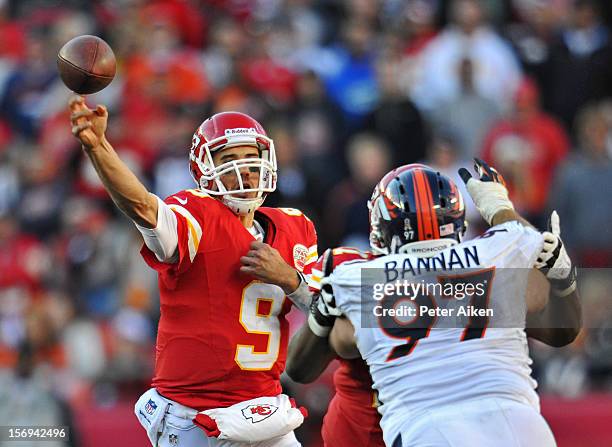 Quarterback Brady Quinn of the Kansas City Chiefs throws a pass under pressure from nose tackle Justin Bannan of the Denver Broncos during the second...