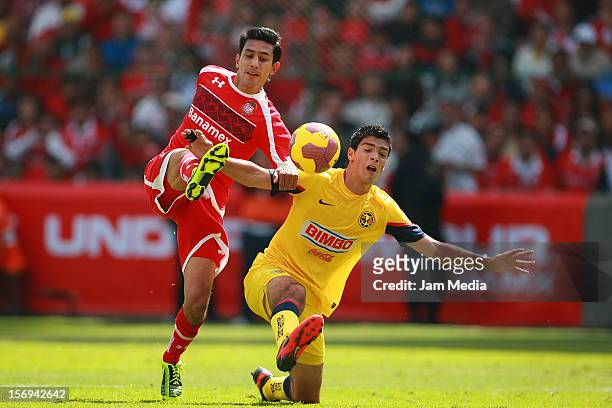Marvin Cabrera of Toluca fights for the ball with Raul Jimenez of America during a match between Toluca and America as part of the Apertura 2012 Liga...
