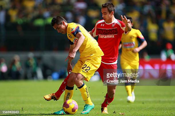 Gerardo Rodriguez of Toluca fights for the ball with Paul Aguilar of America during a match between Toluca and America as part of the Apertura 2012...