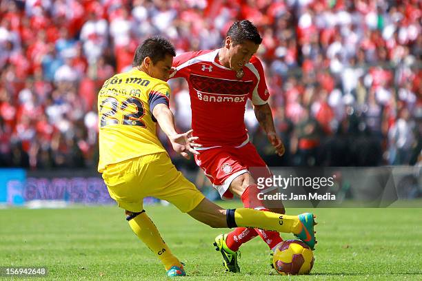 Carlos Esquivel of Toluca fights for the ball with Paul Aguilar of America during a match between Toluca and America as part of the Apertura 2012...