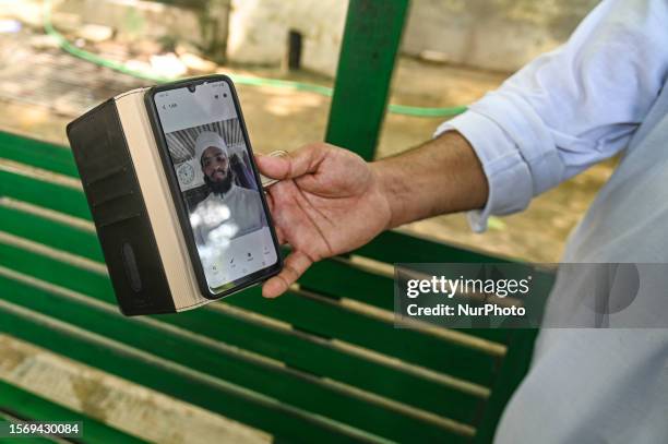 Shadab Anwar , brother of Maulana Saad, who was killed during an attack on a mosque allegedly by a mob on Tuesday midnight, shows a photo of his...