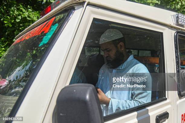 Shadab Anwar, brother of Maulana Saad, who was killed during an attack on a mosque allegedly by a mob on Tuesday midnight, sits inside an ambulance...
