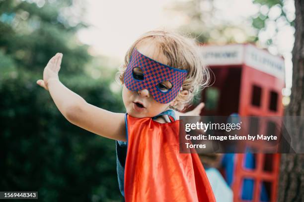 boy dressed as a superhero turning - torres stock pictures, royalty-free photos & images