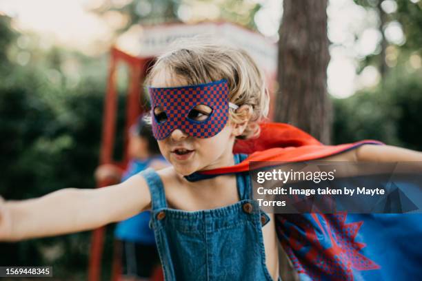 boy dressed as a superhero with arms open - solo bambini maschi foto e immagini stock