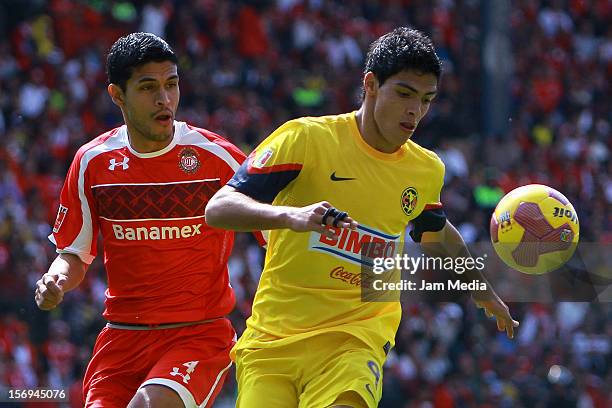 Francisco Gamboa of Toluca fights for the ball with Raul Jimenez of America during a match between Toluca and America as part of the Apertura 2012...