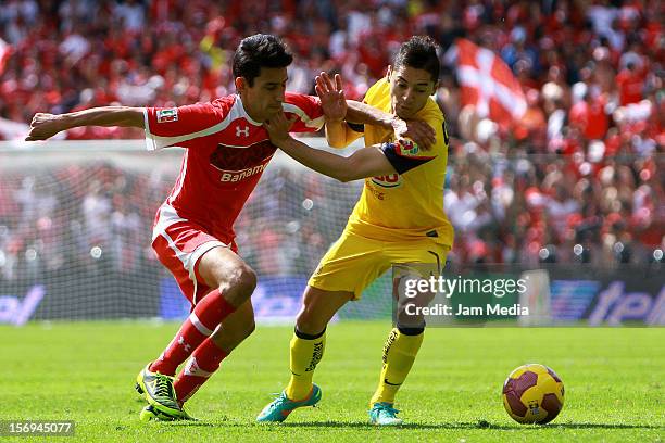 Marvin Cabrera of Toluca fights for the ball with Jose Maria Cardenas of America during a match between Toluca and America as part of the Apertura...