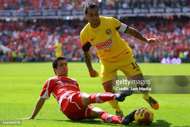 Edy Brambilia of Toluca fights for the ball with Jose Daniel Montenegro of America during a match between Toluca and America as part of the Apertura...