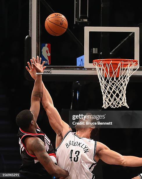 Brook Lopez of the Brooklyn Nets blocks a shot by Wesley Matthews of the Portland Trail Blazers at the Barclays Center on November 25, 2012 in the...