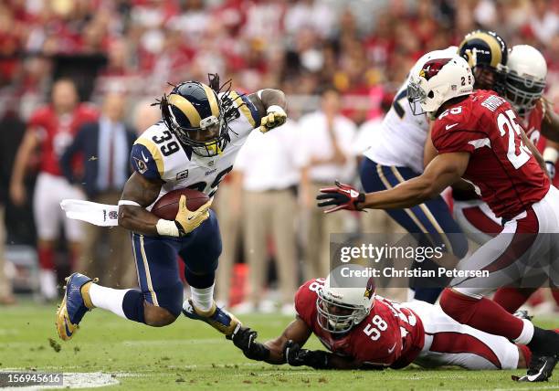 Running back Steven Jackson of the St. Louis Rams is tripped up by inside linebacker Daryl Washington of the Arizona Cardinals as he rushes the...