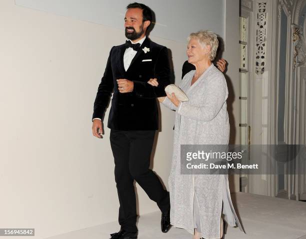 Evgeny Lebedev walks Dame Judi Dench to the stage to collect the Moscow Art Theatre's Golden Seagull award at the 58th London Evening Standard...
